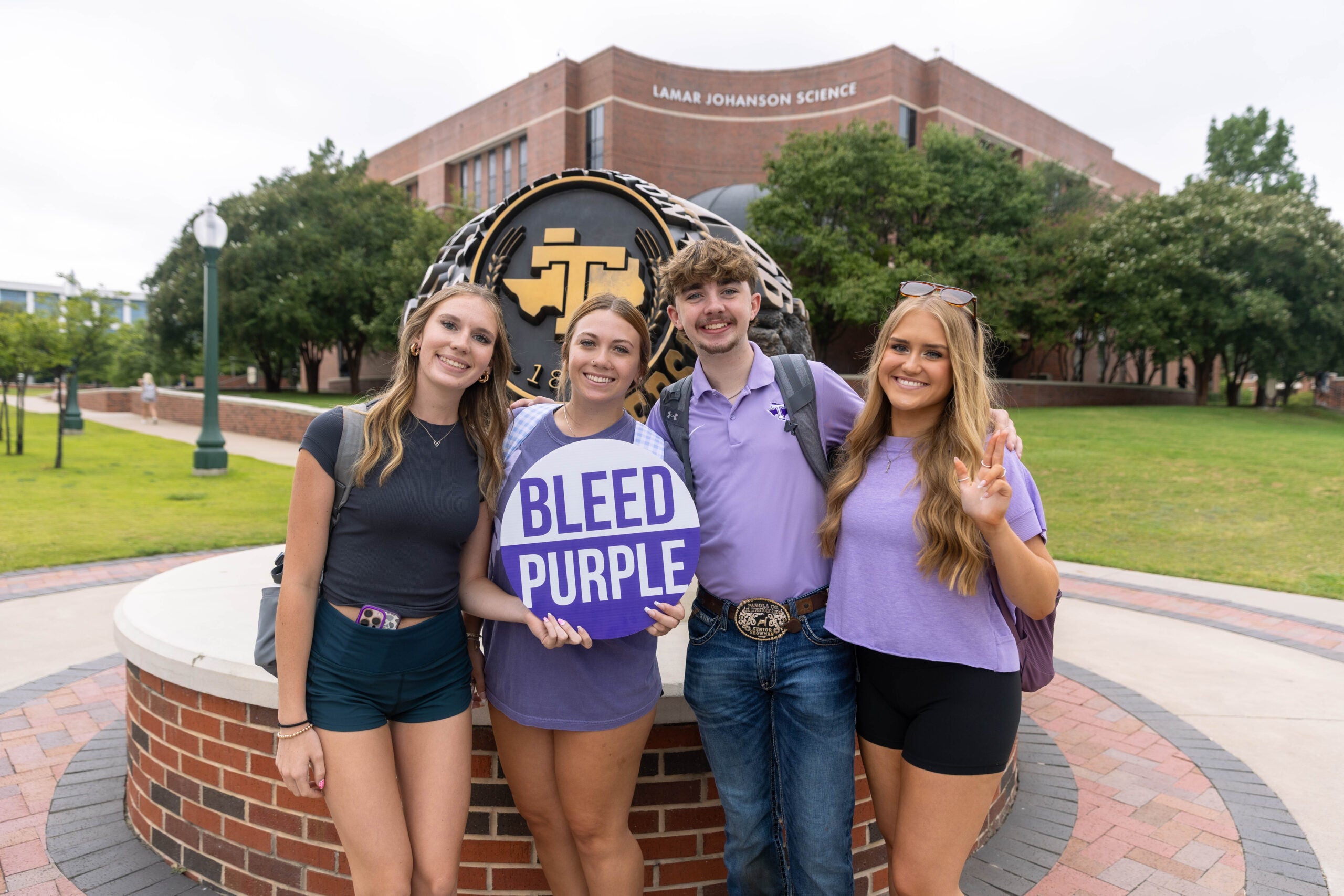 Students in front of the Tarleton State ring statue.