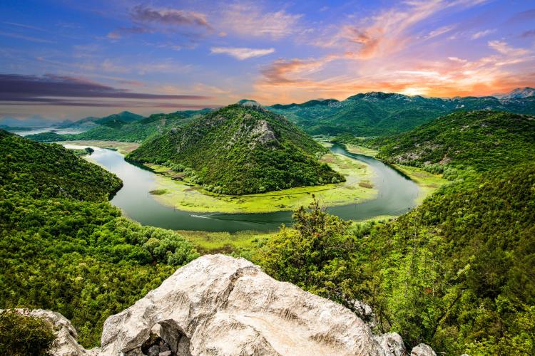 Scenic view of the Rijeka Crnojevica river bend at sunset from Pavlova Strana viewpoint in Lake Scutari National Park, Montenegro.
