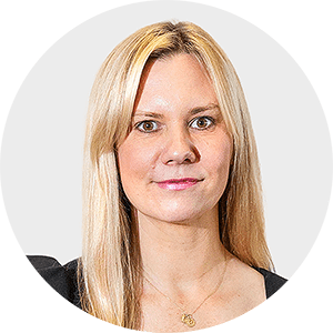 a woman with blonde hair is wearing a black top and a gold necklace