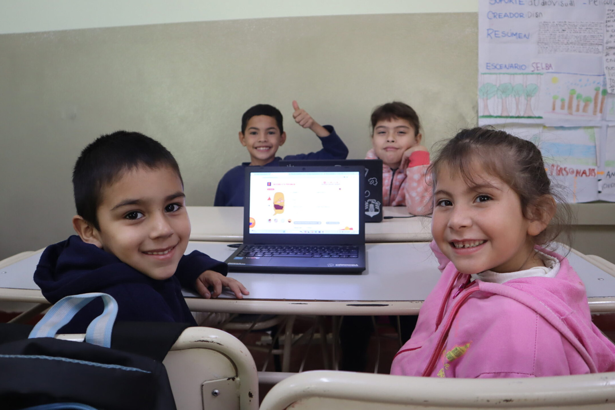 A group of Argentinian students inside the classroom looks at the camera.