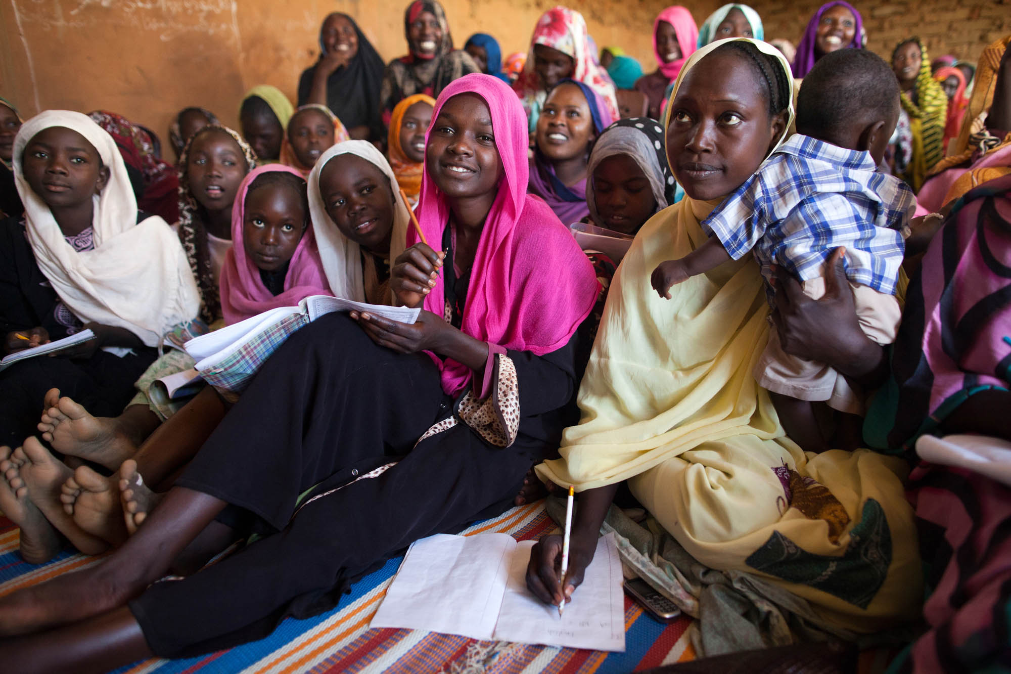 A group of displaced young women attending an English class in North Darfur, Sudan.