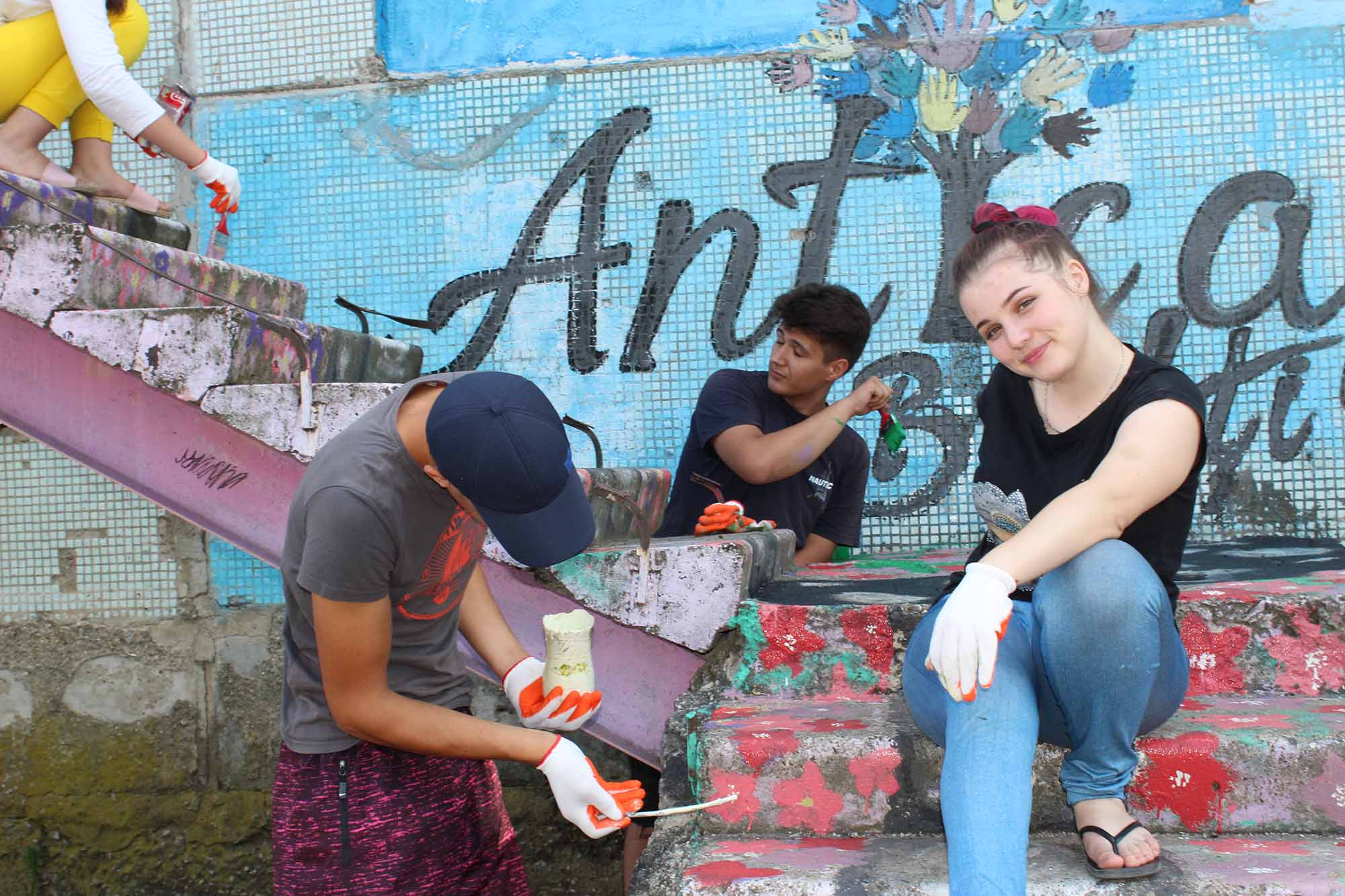 Young people from Kosovo and Albania collaborating on a mural as part of a community art project.