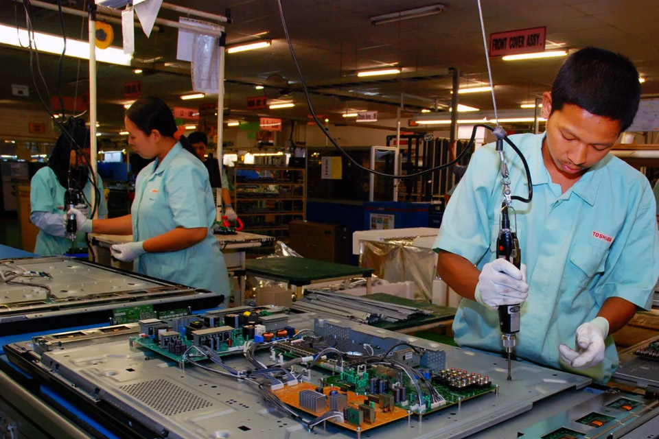 Workers assembling electronics products in a factory.