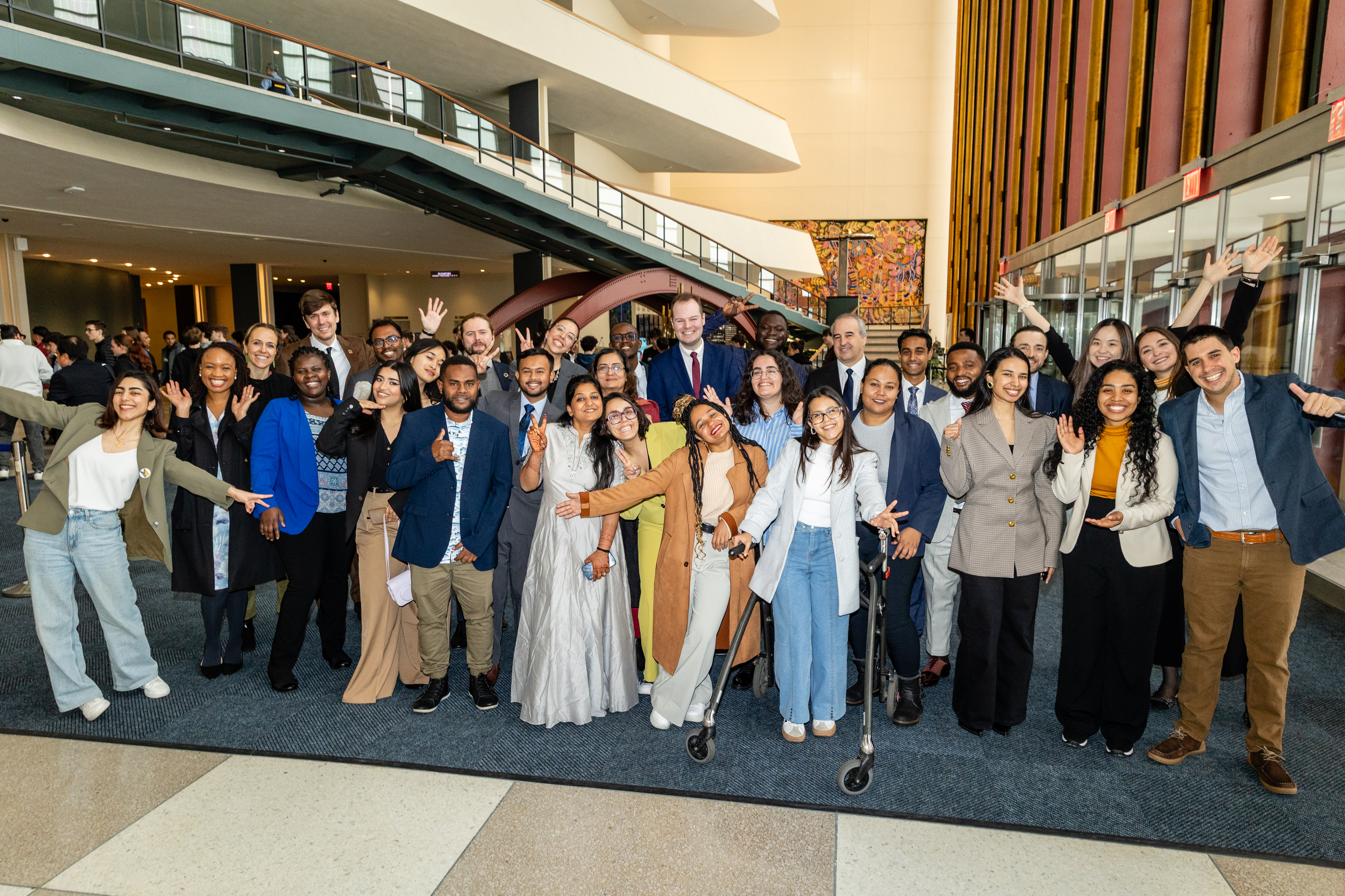 A photograph showing a lerge group of people, the staff of the UN Youth Office, smiling at the camera