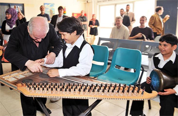 Maestro Barenboim with one of the young musicians of the Al-Qattan foundation who performed for him in honour of Mr. Barenboim’s first-ever visit to the Gaza Strip in May 2011, to perform a peace concert for the people of Gaza. UN Photo/Shareef Sarhan