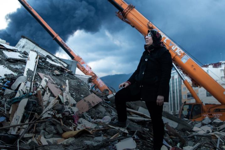 woman amid earthquake destruction