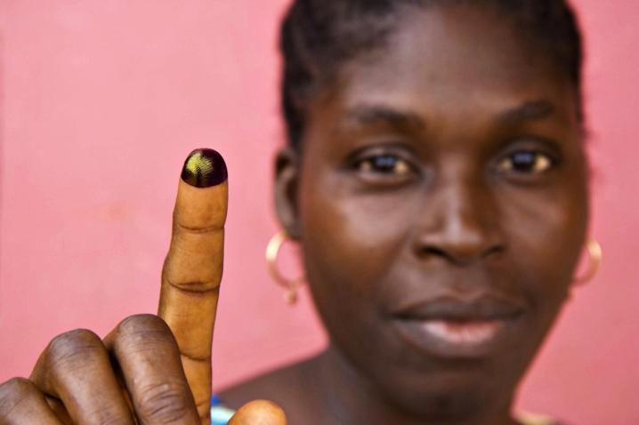 A lady showing her inked finger.