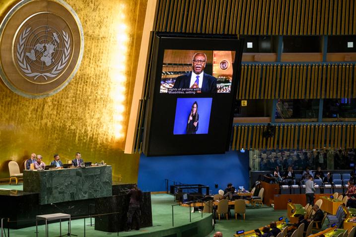 Link to the 18th Session of Conference of States Parties to Convention on Rights of Persons with Disabilities Philemon Yang (on screen) delivers a message in the GA Hall, an sign language interpreter is shown on the screen