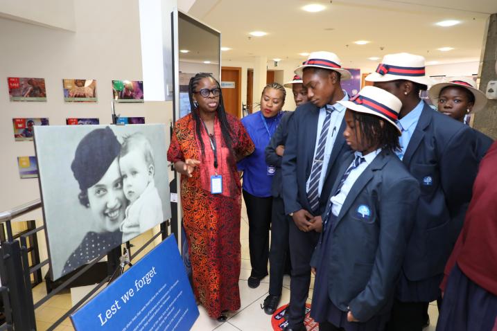 A group of students walking through a holocaust exhibition.