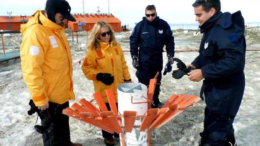 Celeste examining glacier indicator instruments with others