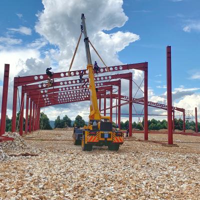 A crane holding a steel bar at a tea factory construction site in Kyamuhunga Town Council in Western Uganda by Baluku Brian/Wikimedia Commons. 