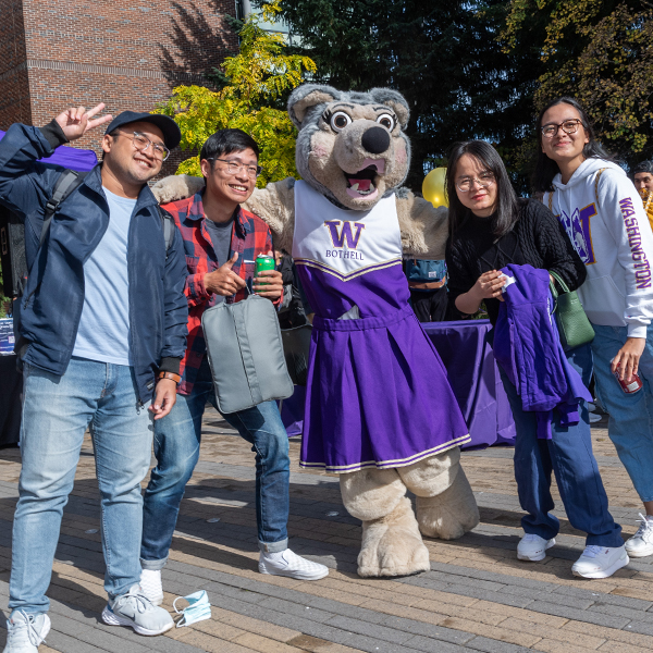Students pose with Holly the Husky at the 2023 W Day Celebration.